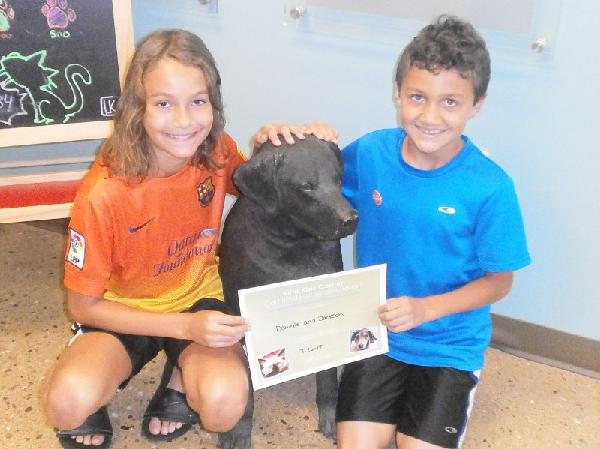 Danielle and Jackson smile with "Blackie."